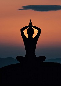A woman silhouette sitting put the hand together above the head or doing yoga on the mountain in front of the moon sports sky spirituality.