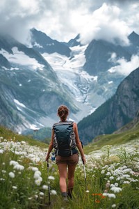 Woman hiking in the mountains adventure backpacking recreation.