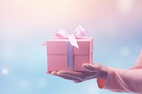 Person holding gifts gradient background pink box celebration.