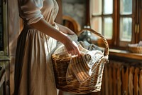 Woman holding basket of laundry adult woman midsection.