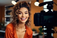 A young woman enjoying make up while recording video adult smile photo.