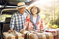 Elder japanese american couple luggage suitcase vacation.