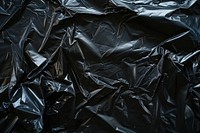 Black plastic wrap backgrounds monochrome crumpled.