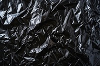 Black plastic wrap backgrounds monochrome crumpled.