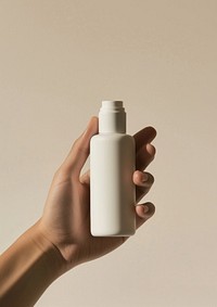 Hand holding skincare bottle cosmetics container medicine.