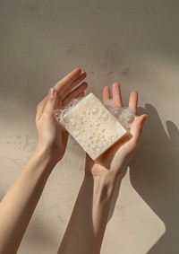 Bar soap holding hand medication.