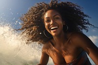 Happy African woman surfer laughing portrait outdoors.