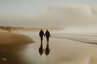 Older couple walking together beach outdoors nature.