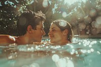 Boyfriend and girlfriend enjoying together in swimming pool portrait photo day.
