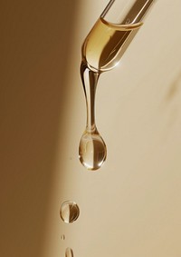Clear oil serum flowing out of the skincare dropper refreshment simplicity splashing.