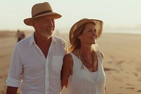 Middle-aged couple walking together summer beach adult.