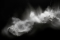 White dust stains on black monochrome exploding splashing.