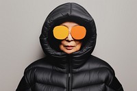 Old woman wearing an black oversized puffer jacket hood sweatshirt portrait.