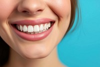 Girl showing beautiful white smile teeth skin blue.