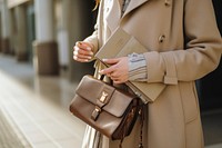 Overcoat handbag holding purse.