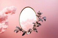 Leaves with golden oval frame mirror plant cloud photo.