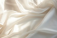 Minimal photo of a white sheet backgrounds silk crumpled.
