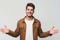 Young handsome caucasian man over isolated background extending hands to the side for inviting to come portrait jacket smile.