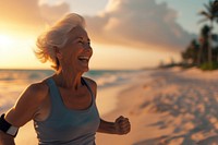 Elderly woman running beach adult retirement.