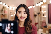 A asian girl take a selfie with video recording in front smile adult photo.