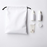 Blank white cotton flat drawstring pouch put on basin in the hotel bathroom bag bottle lotion.