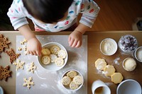 Photo of asian kid decorating cookies food baby confectionery.