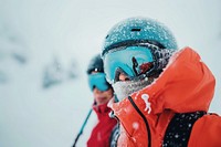 Couple skiing on mountain outdoors recreation helmet.