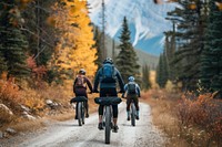 Mountain biking women and man riding on bikes mountain outdoors vacation.