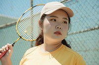 Asian woman holding badminton racket sports outdoors tennis.