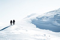 Couple walking hiking in the snow mountain outdoors recreation adventure.