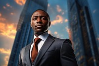 Black businessman with skyscrapers backdrop architecture building portrait.