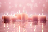 Candles on pink water pattern spirituality illuminated celebration.