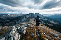 Man trail running in rocky mountains adventure outdoors hiking.