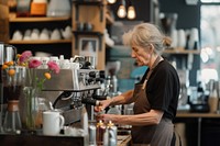 Mature woman barista in coffee shop entrepreneur coffeemaker freshness.