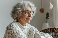 Mature woman watching tutorials for knitting sweater adult white.