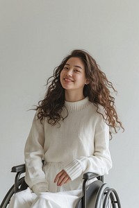 A disabled maature woman wheelchair sweater smiling.