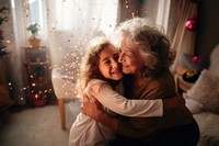 Latino little girl hug her grandmother portrait hugging adult.