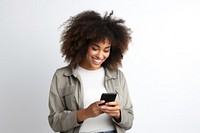Positive curly haired ethnic woman uses mobile phone checks messages and reads news holds modern cellular in hands portrait adult photo.