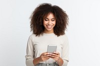 Positive curly haired ethnic woman uses mobile phone checks messages and reads news holds modern cellular in hands adult smile photo.