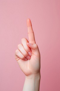 The finger of a woman displaying the okay sign hand gesturing holding.