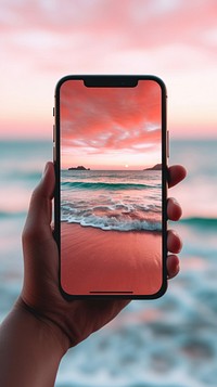 Woman using smartphone sea outdoors sunset.