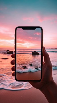 Woman using smartphone sea outdoors sunset.