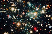 Stars flying around in a dark backgrounds christmas fireworks.