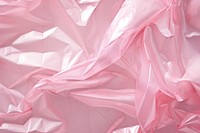 Cellophane texture pink silk backgrounds.