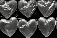 Plastic wrap with heart patterns backgrounds black background monochrome.