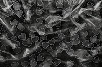 Plastic wrap with heart patterns backgrounds black smoke.