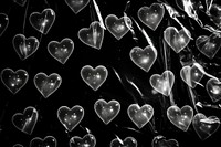 Plastic wrap with heart patterns backgrounds black black background.