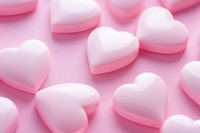 Hearts shaped confectionery backgrounds pink.