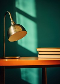 A lamp and book on a table with mirror lampshade lighting architecture.