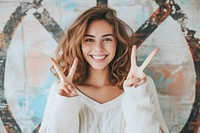 Woman with two finger person smile happy.
